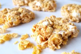 four cornflake cookies surrounded by cornflakes