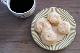 overhead image of pastries on a green plate next to a mug of coffee