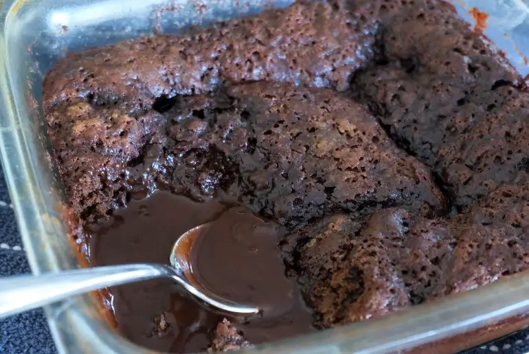 pan of pudding cake with a spoon in it