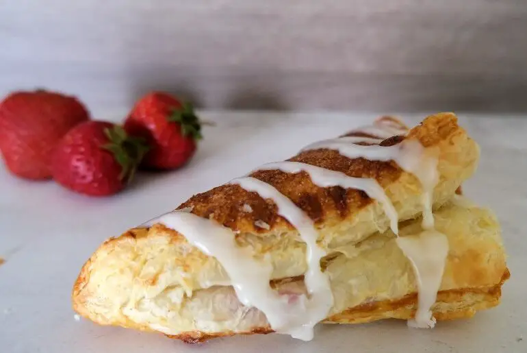 strawberry turnover with strawberries in the background