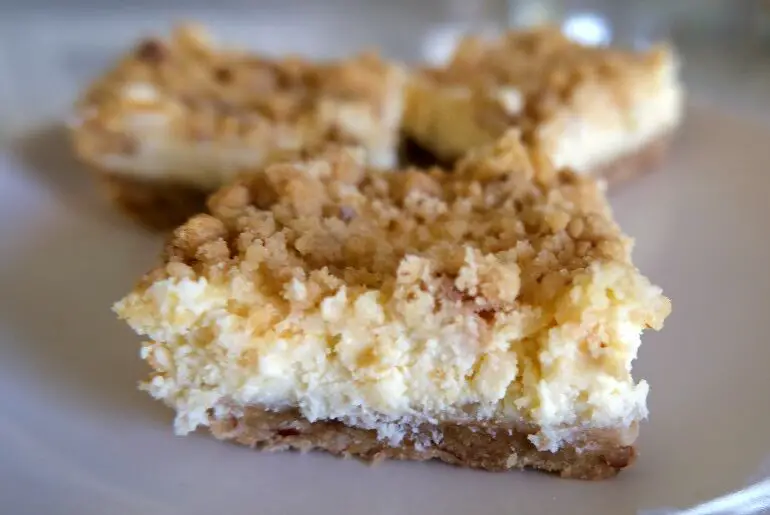3 cheese cake bars on a white plate