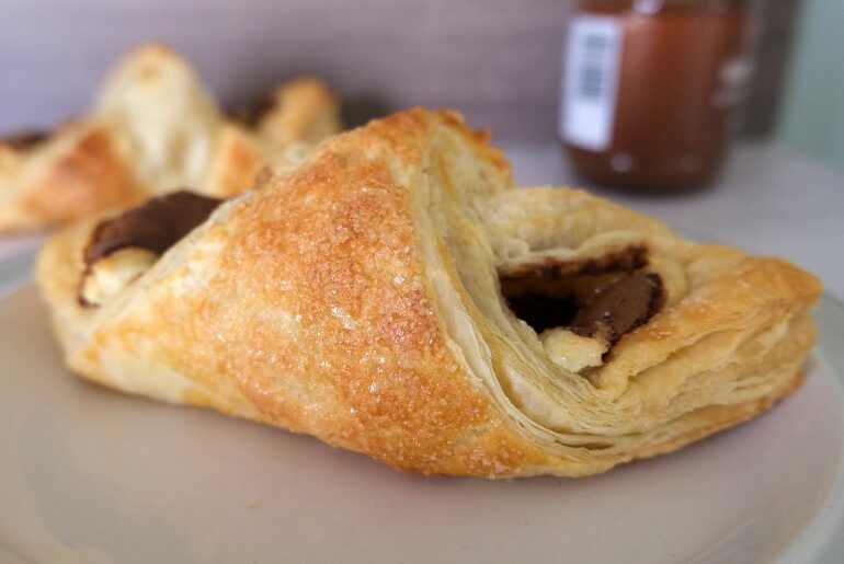 close up nutella danish with nutella in the background